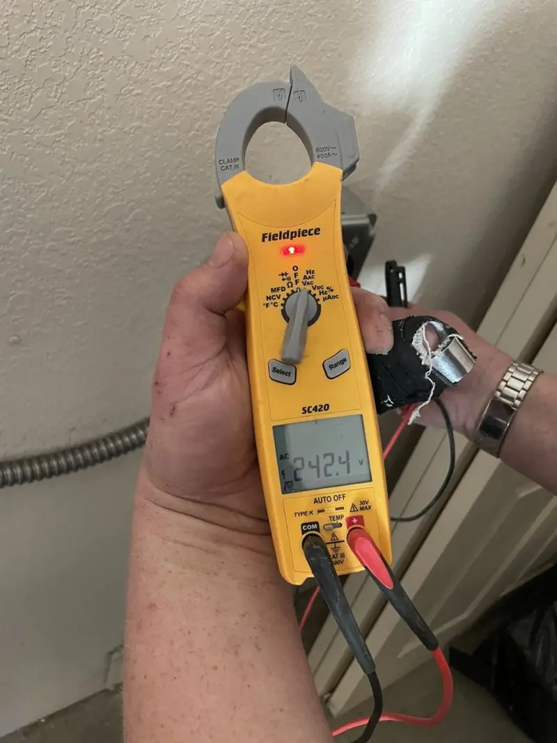 Voltage testing with clamp meter during Outlet Installation in Fergus Falls